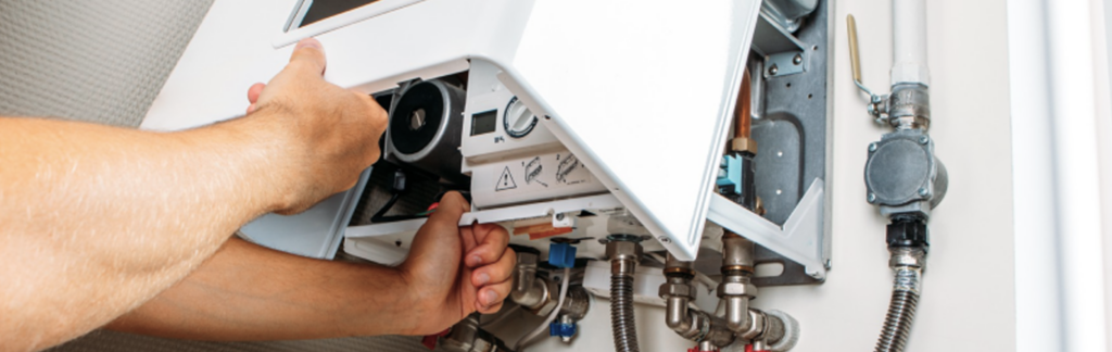 A plumber carefully installing a new water heater in a Panama City, FL home.